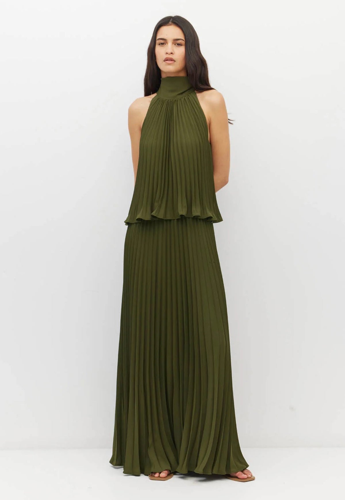 Juliette Hogan sleeveless olive green halter-neck maxi dress with a pleated design.