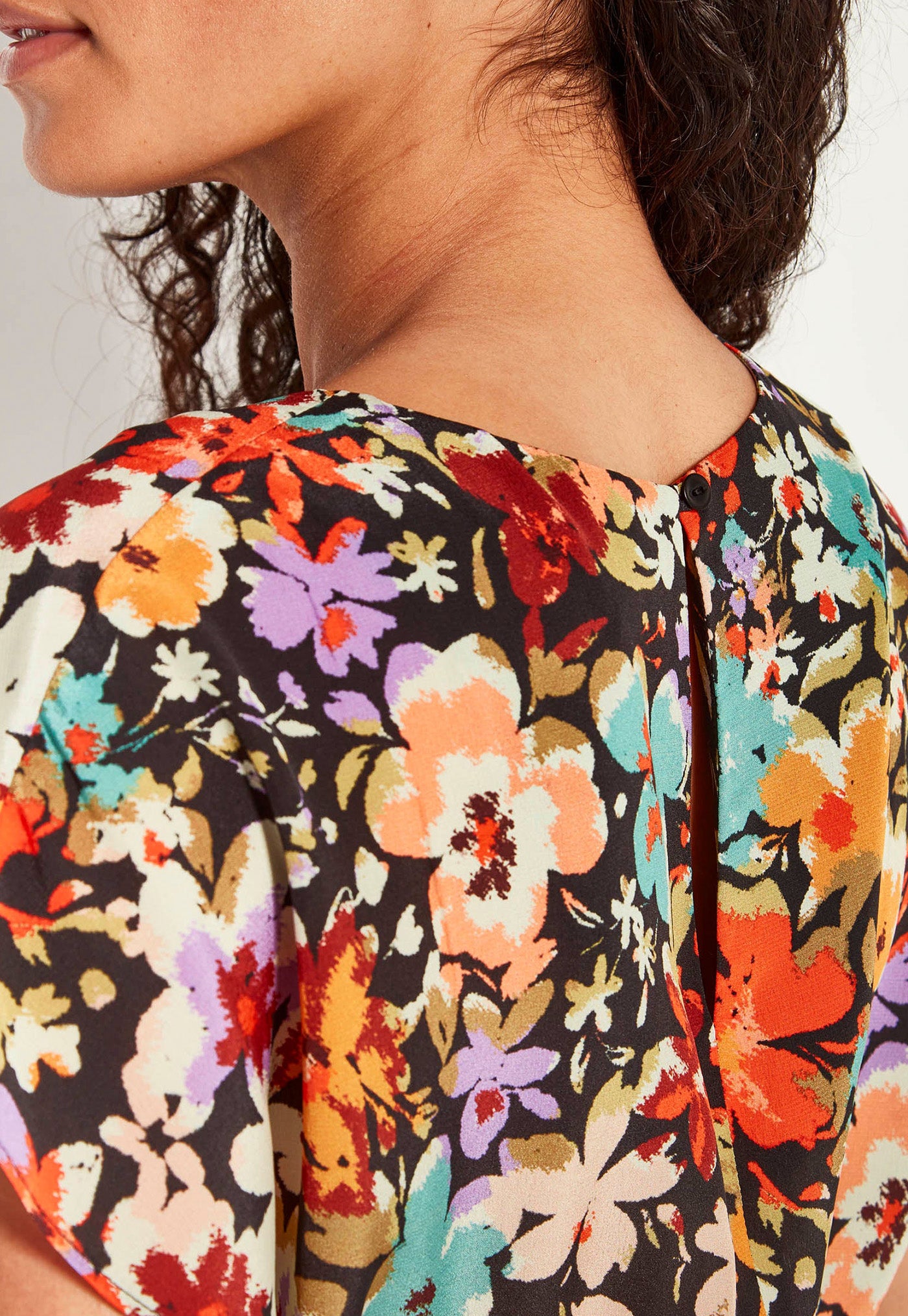 Close-up of a person wearing a colorful floral-patterned garment.