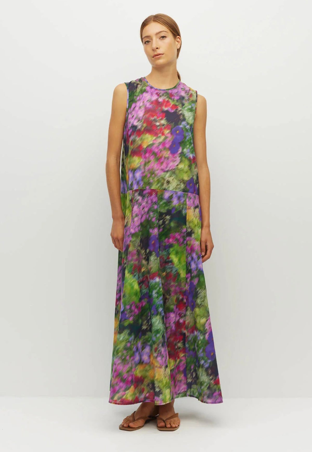 Juliette Hogan sleeveless, high-neck maxi dress with a vibrant multicolor floral and abstract print in shades of purple, green, pink, and blue.