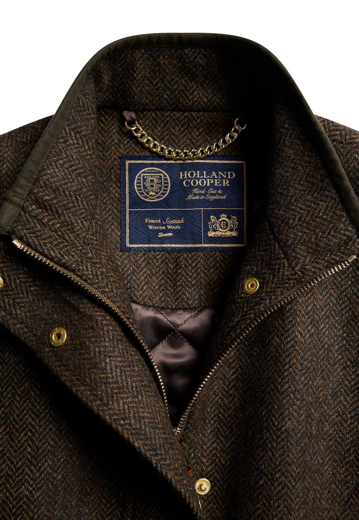 Close-up of the dark green herringbone wool tweed and waxed piping on the Holland Cooper Country Classic Tweed Gilet.