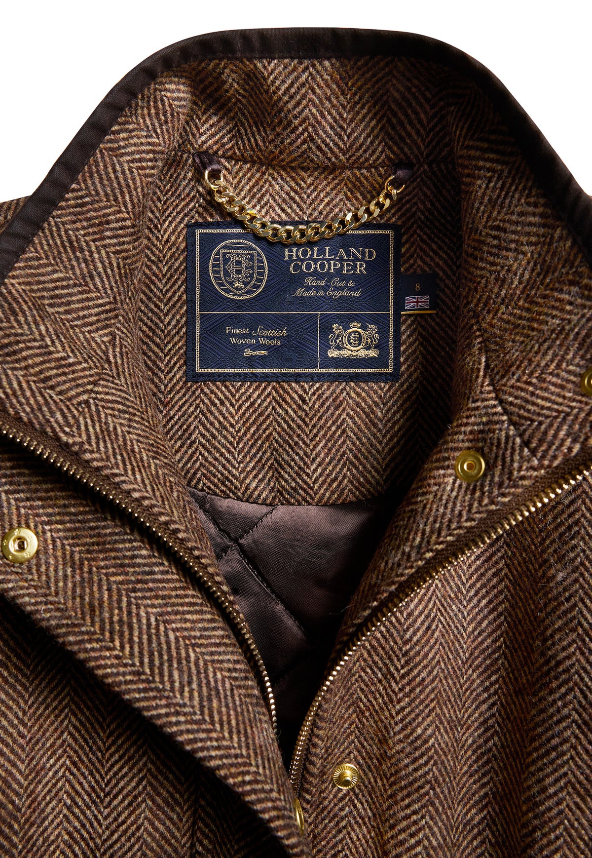 Close-up of the brown herringbone wool tweed and waxed piping on the Holland Cooper Country Classic Tweed Gilet.