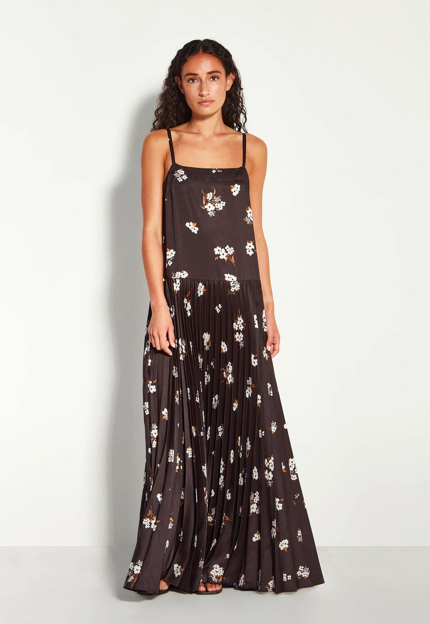 Woman wearing a black floral dress on a white background
