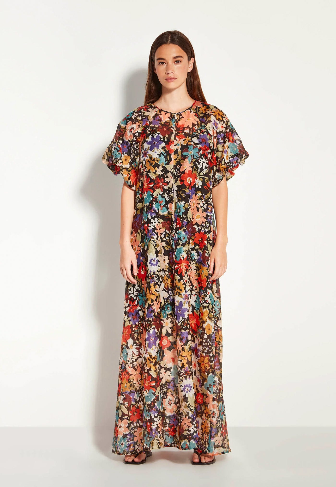 Woman wearing a floral dress on a white background