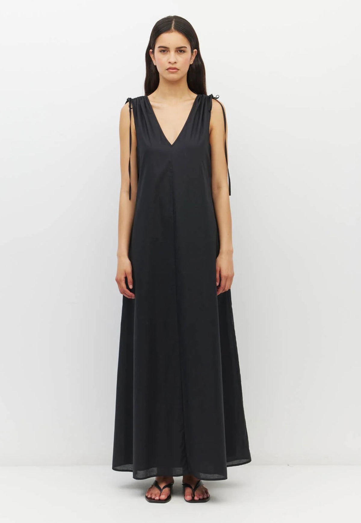 Juliette Hogan, 100% cotton, long black sleeveless maxi dress with a V-neckline and thin shoulder ties.