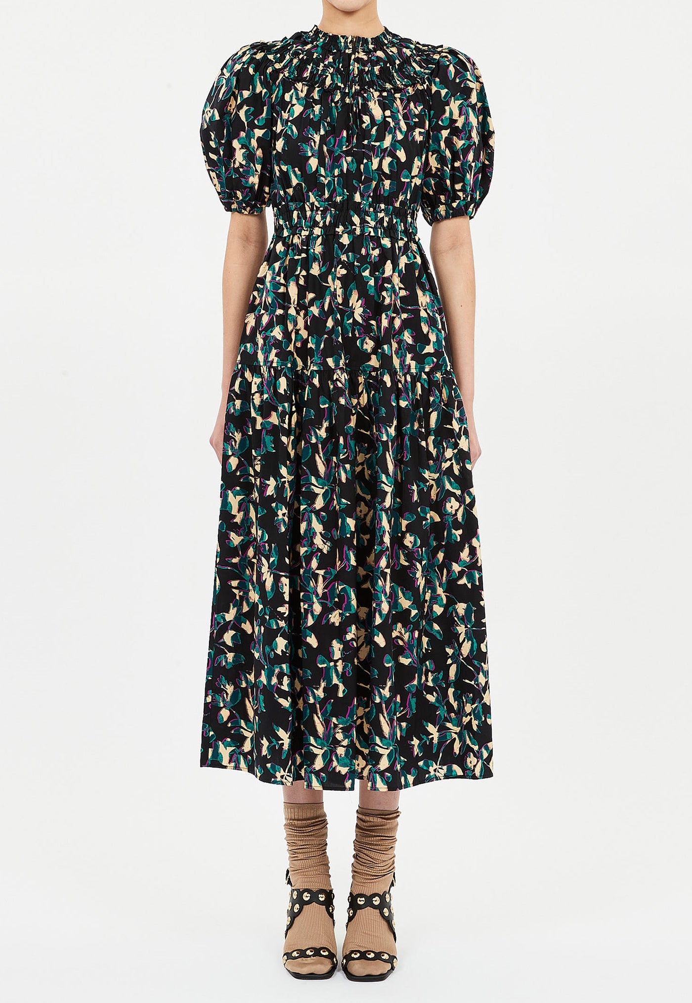 Woman wearing a patterned dress on a white background