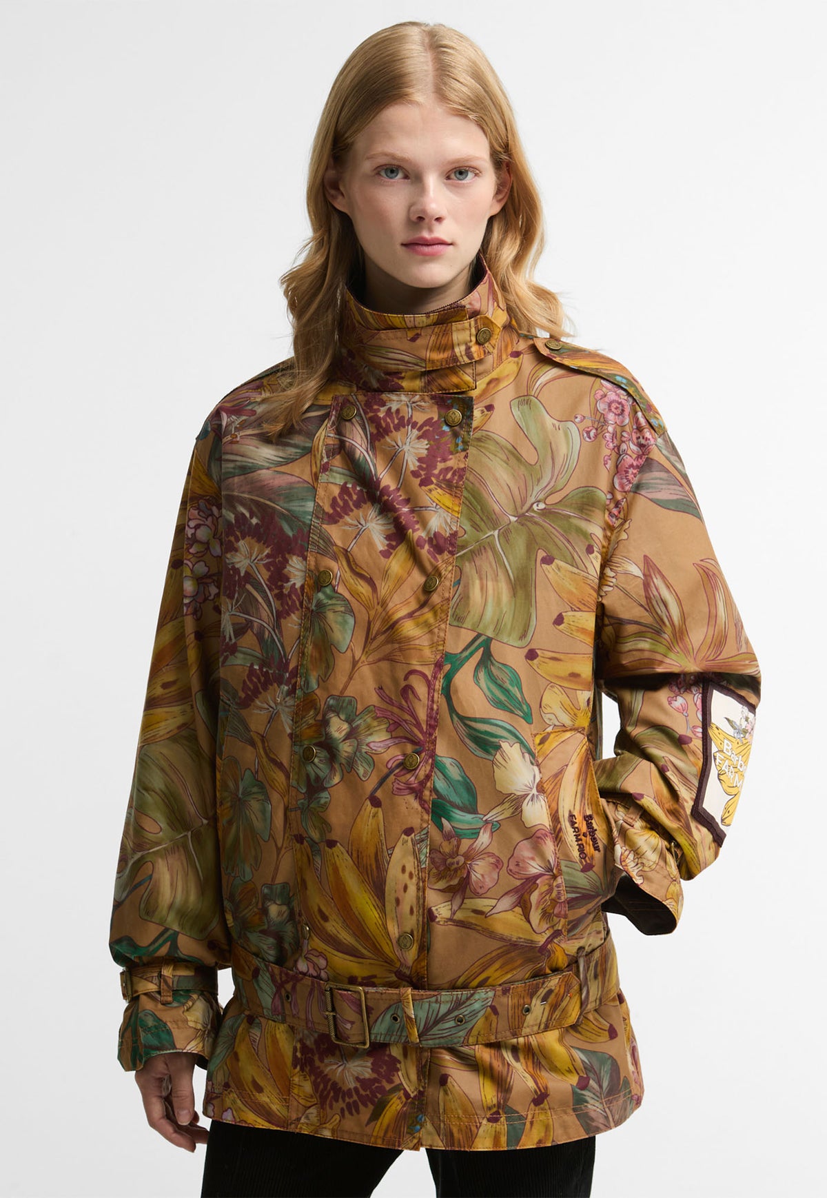 Barbour x FARM Rio Attalea Waxed Jacket in Banana Groove print, a waxed cotton trench style jacket with belted dropped waist.