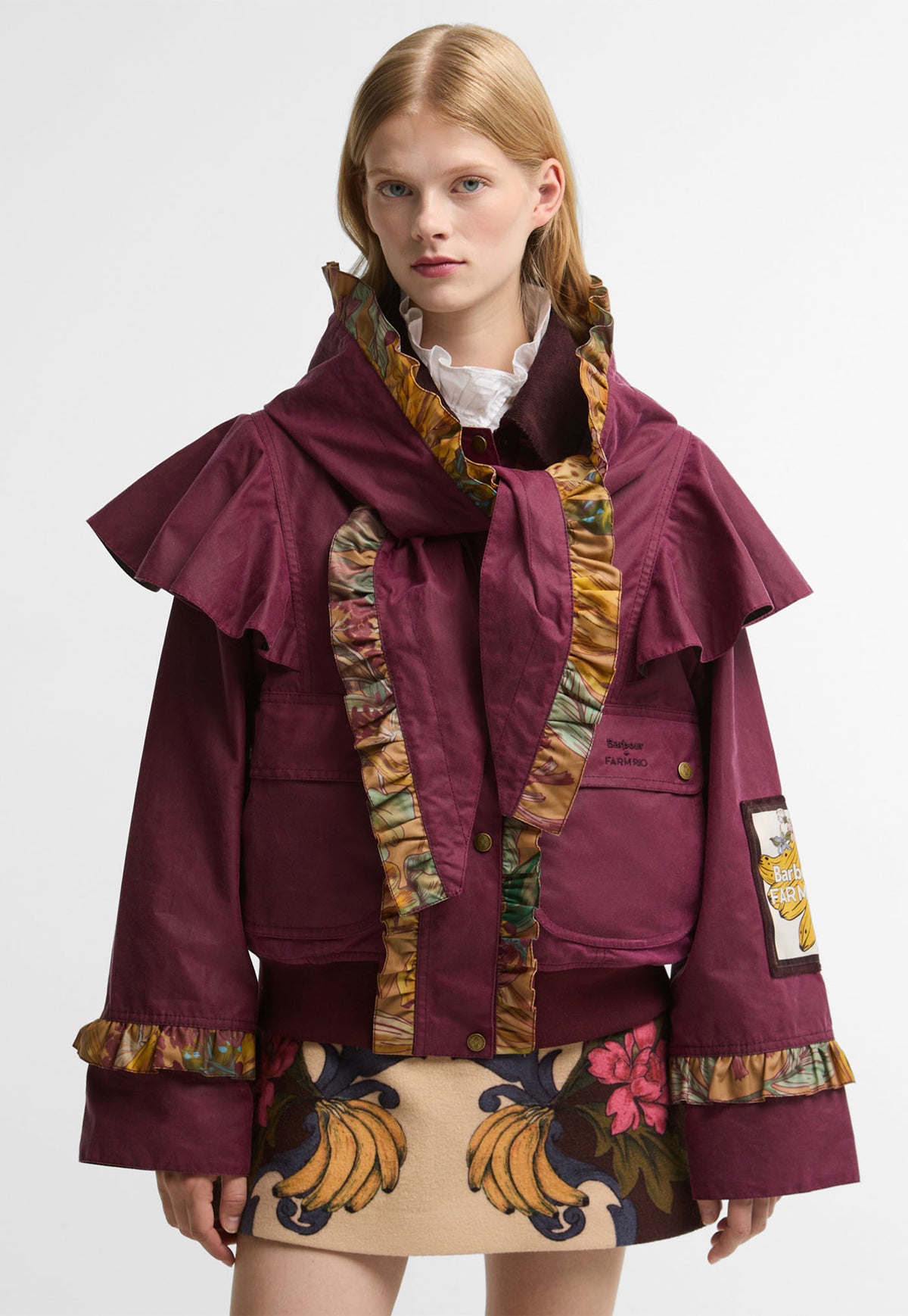 Barbour x FARM Rio Serra Wax Jacket in Wine/Banana Groove, wine waxed cotton cropped jacket with ruffled cape shoulders and Banana Groove print ruffle trims.