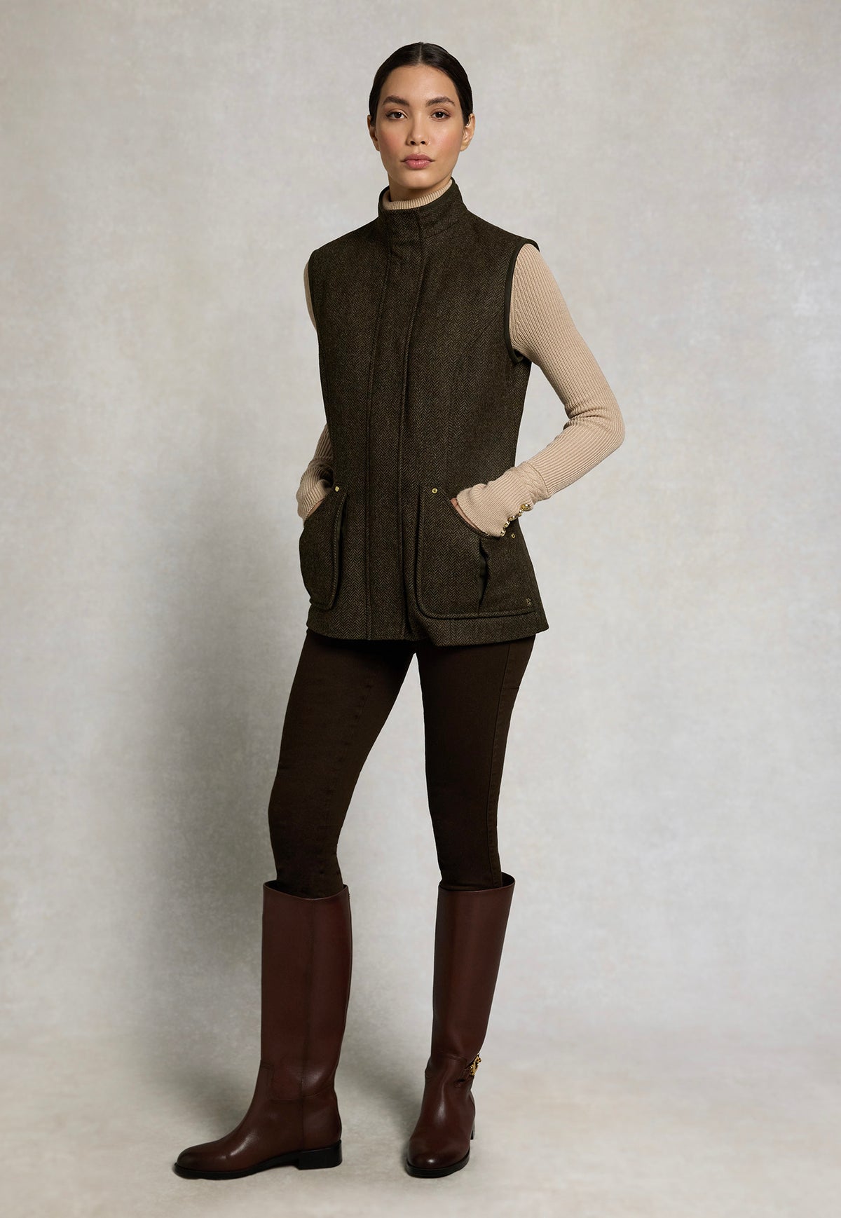 Holland Cooper Country Classic Tweed Gilet in Dark Green Herringbone, featuring patch pockets and a stand collar.